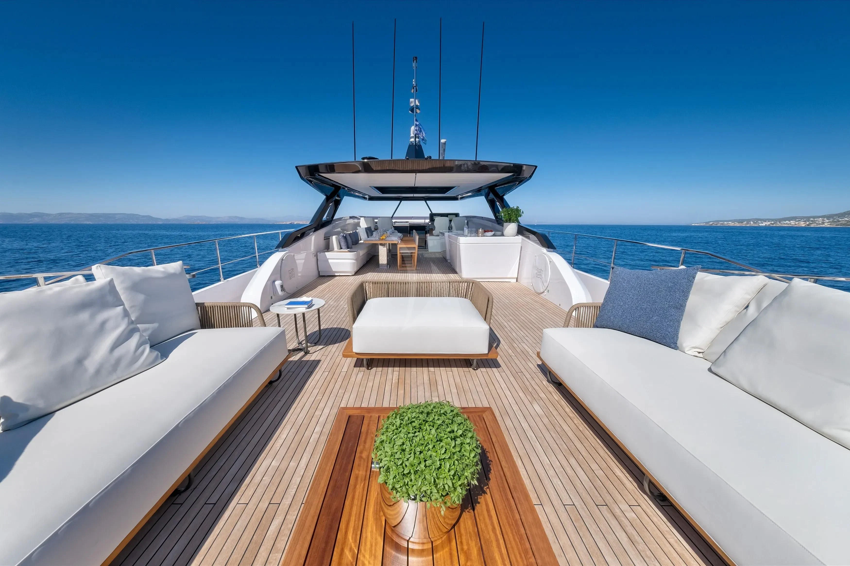 a large bed with a table and chairs on it aboard SPICA Yacht for Sale