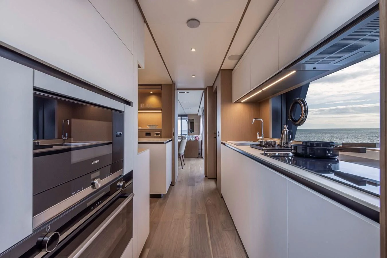 a kitchen with a large window aboard SPICA Yacht for Sale
