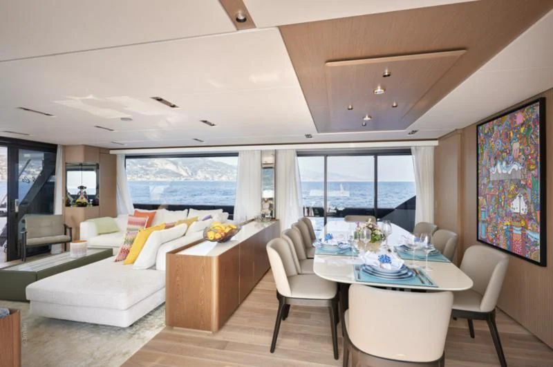 a living room with a table and chairs aboard SPICA Yacht for Sale