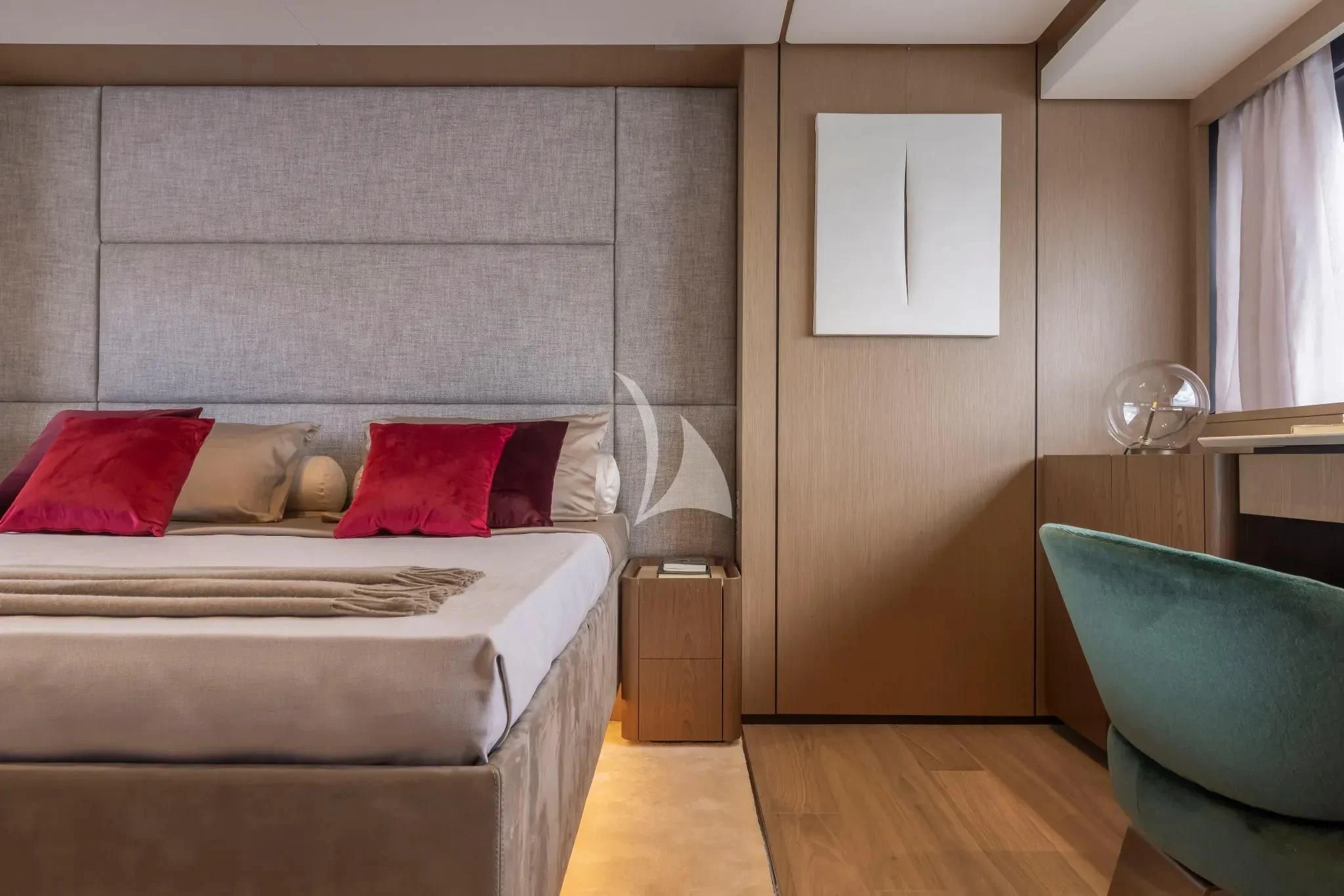 a room with a bed and a chair aboard SPICA Yacht for Sale