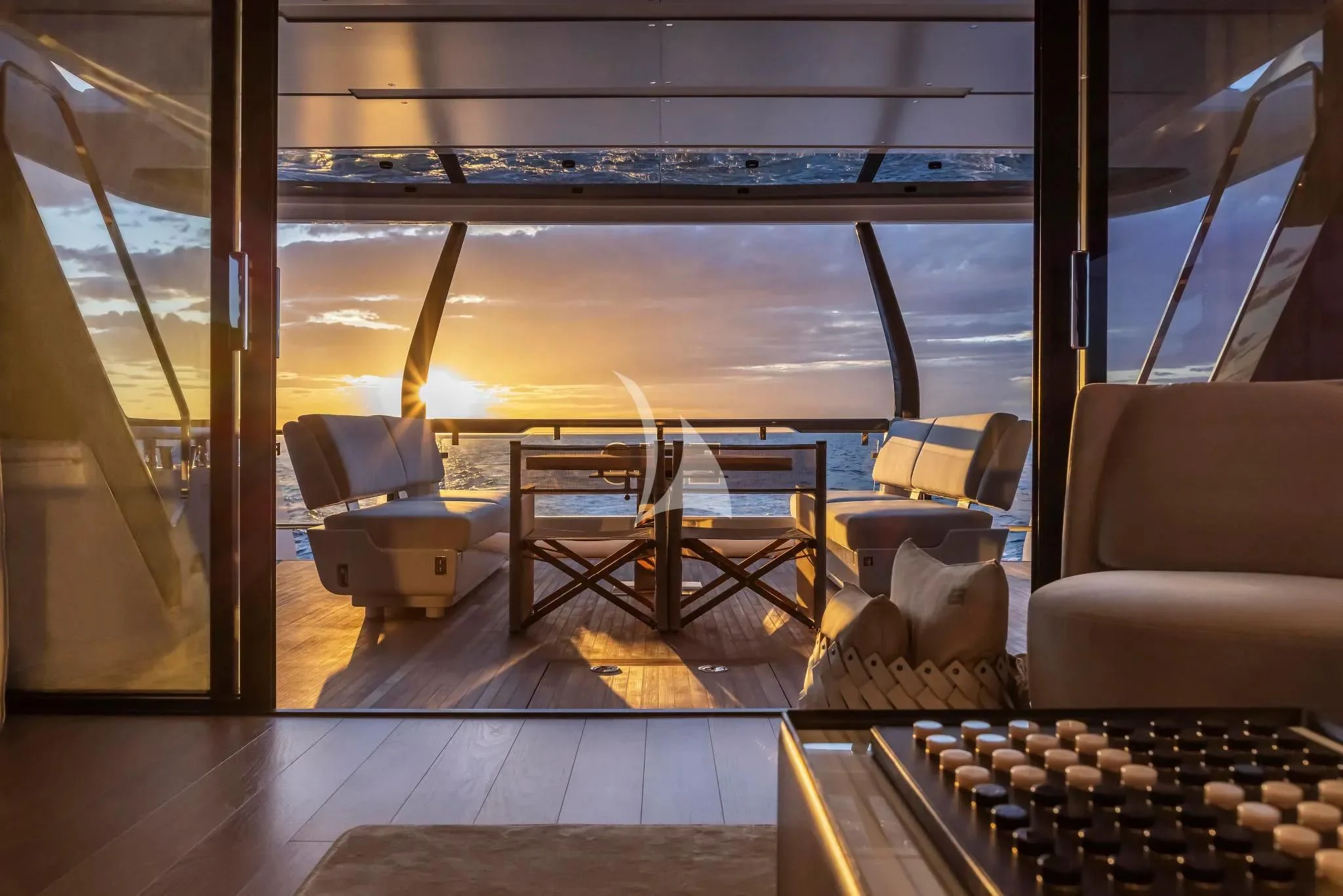 a room with a view of the water and a table aboard SPICA Yacht for Sale