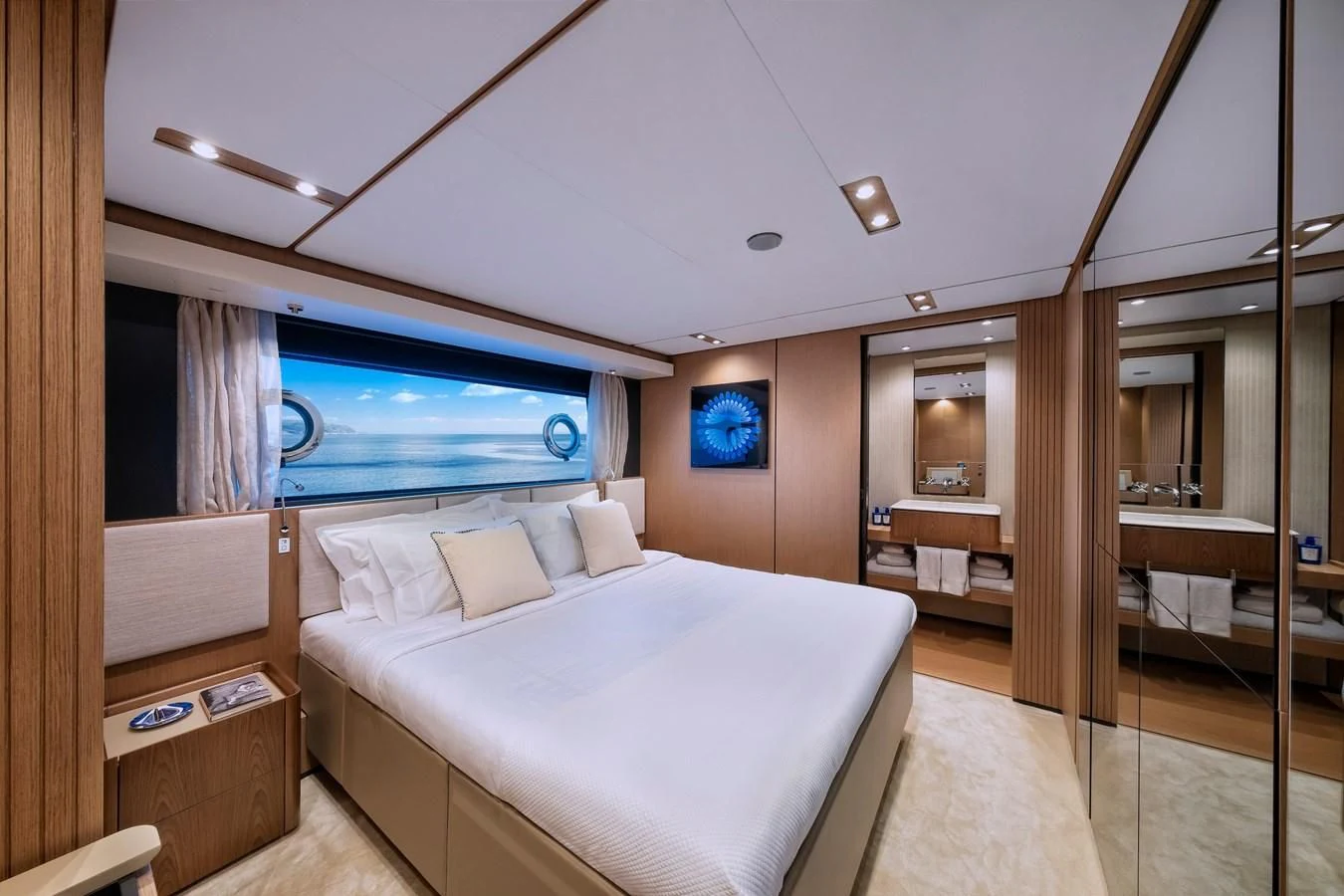 a bedroom with a bed and a mirror aboard SPICA Yacht for Sale