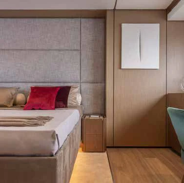 a room with a bed and a pillow aboard SPICA Yacht for Sale