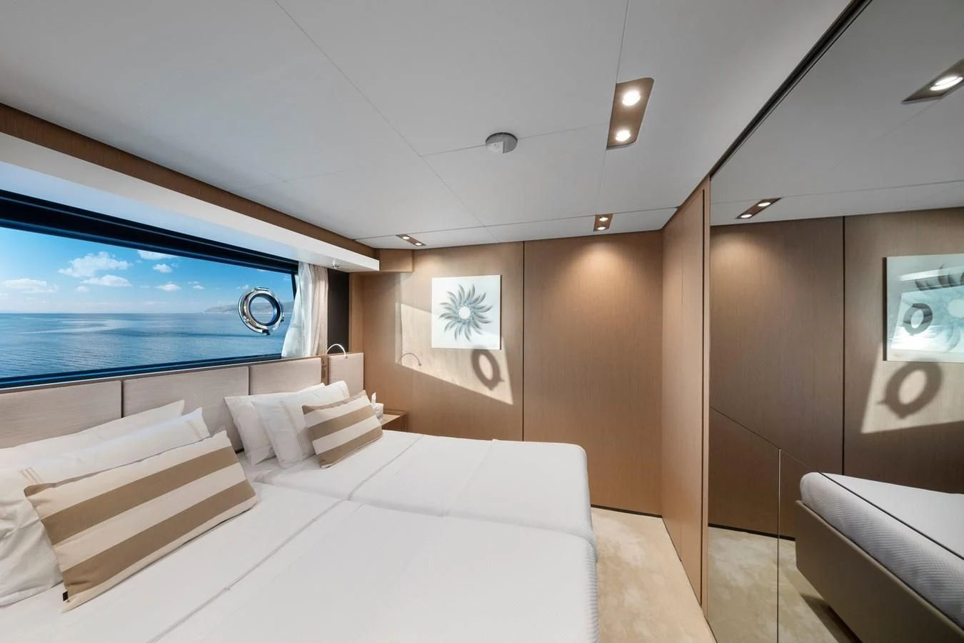 a room with a bed and a window aboard SPICA Yacht for Sale