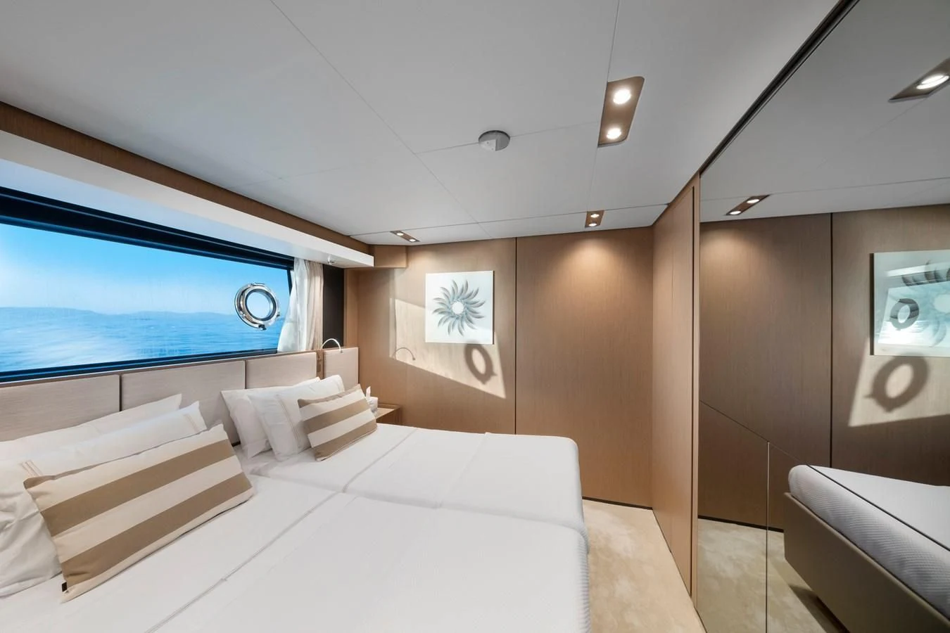 a room with a bed and a window aboard SPICA Yacht for Sale