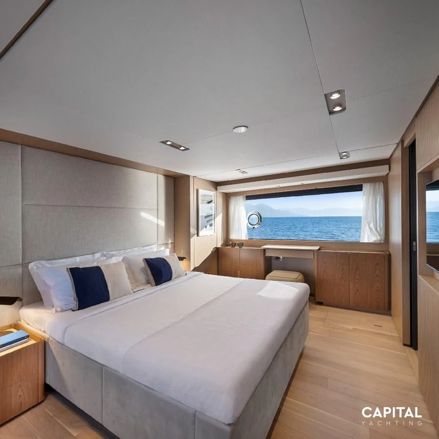 a room with a bed and a window aboard SPICA Yacht for Sale
