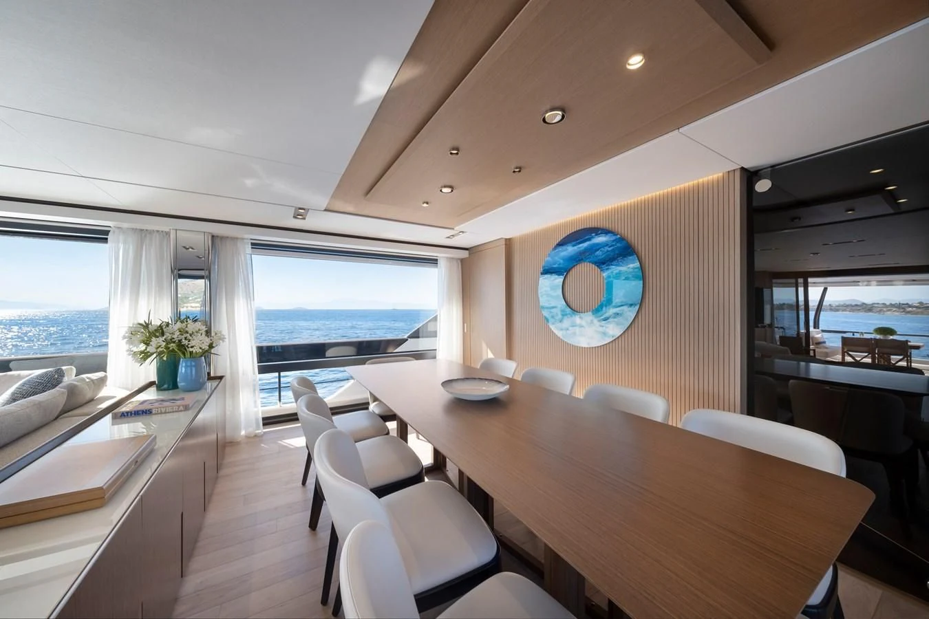 a room with a table chairs and a window aboard SPICA Yacht for Sale