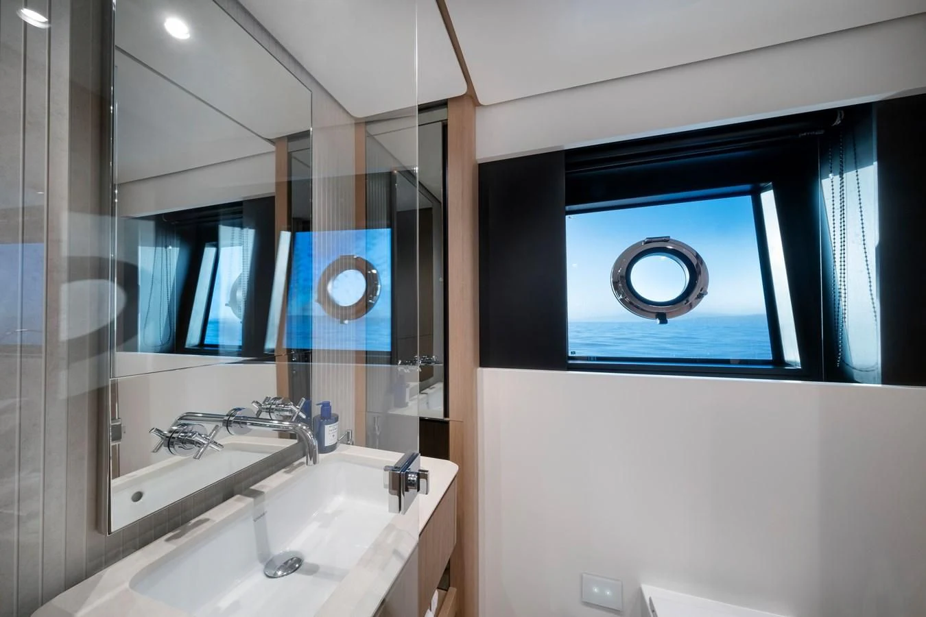 a bathroom with a sink and a large mirror aboard SPICA Yacht for Sale