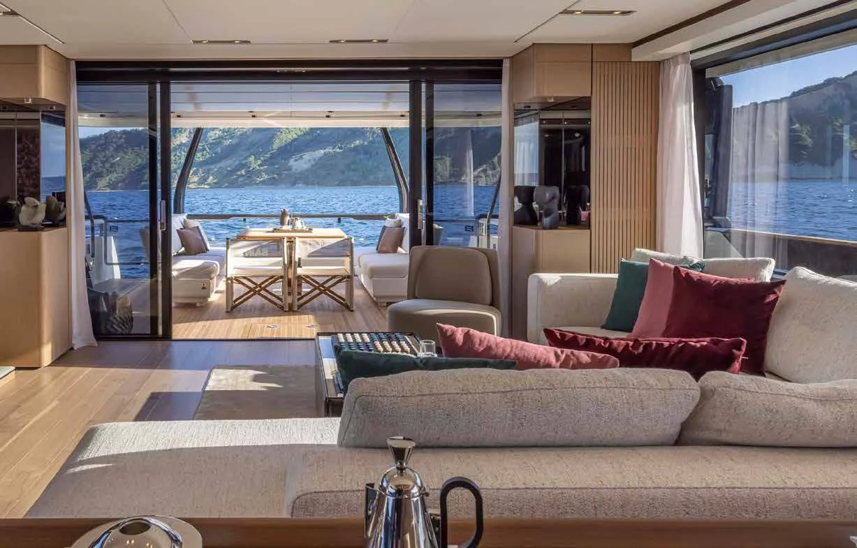 a living room with a couch and a table aboard SPICA Yacht for Sale