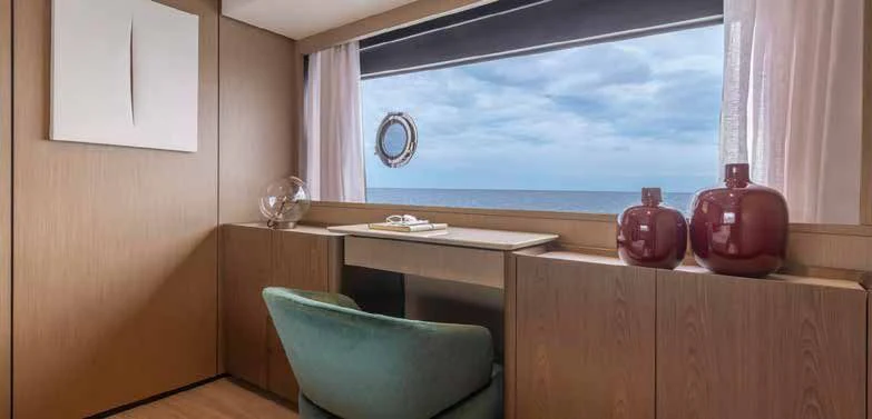 a room with a desk and a window aboard SPICA Yacht for Sale