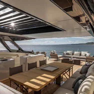 a room with a table and chairs aboard SPICA Yacht for Sale