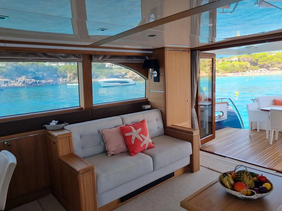 a room with a couch and a table with fruit on it aboard PLEIADES Yacht for Sale