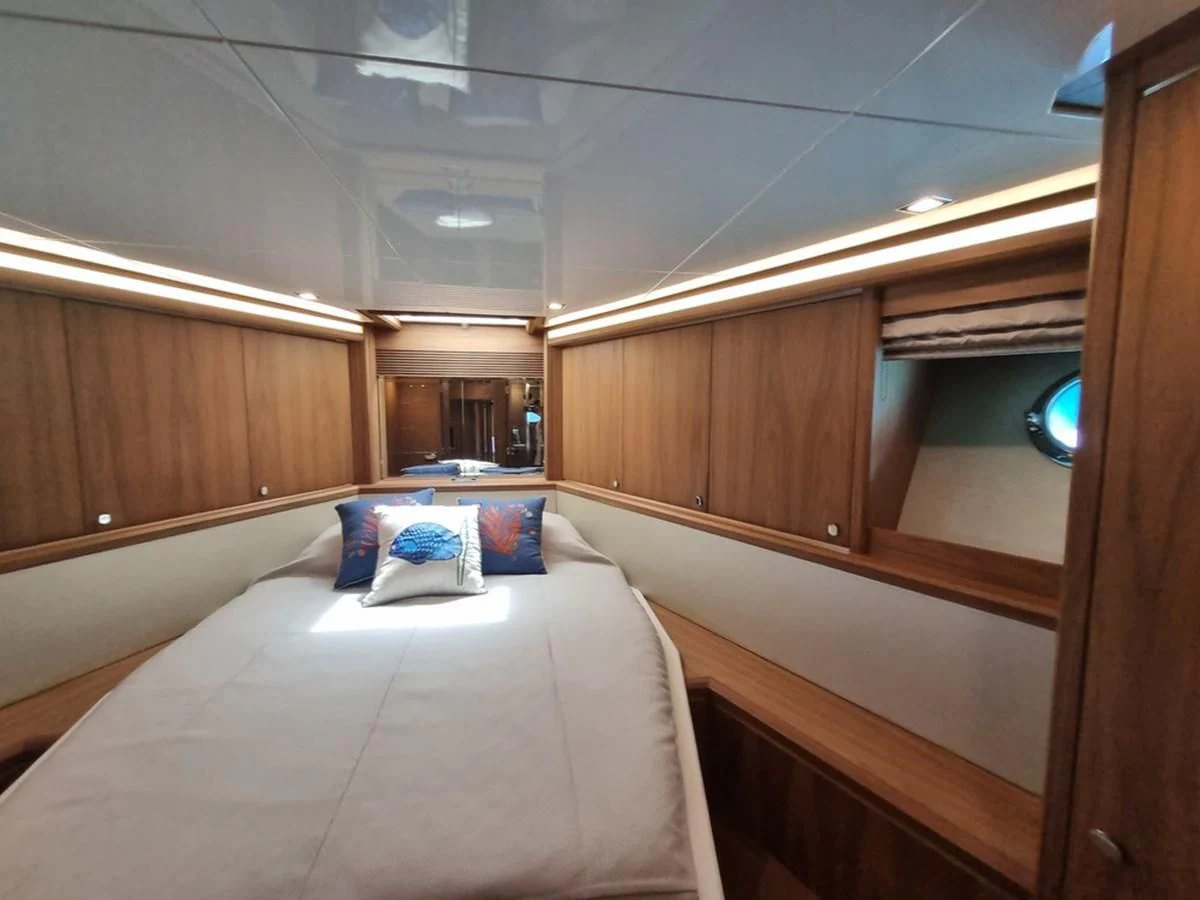 a room with a bed and a mirror aboard PLEIADES Yacht for Sale