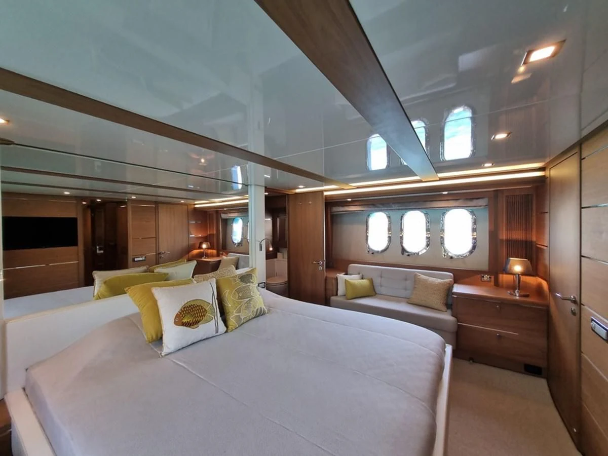 a room with a bed and a large mirror aboard PLEIADES Yacht for Sale