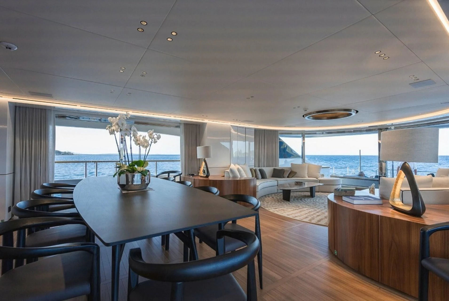 a large room with a table and chairs aboard TOSUN Yacht for Sale