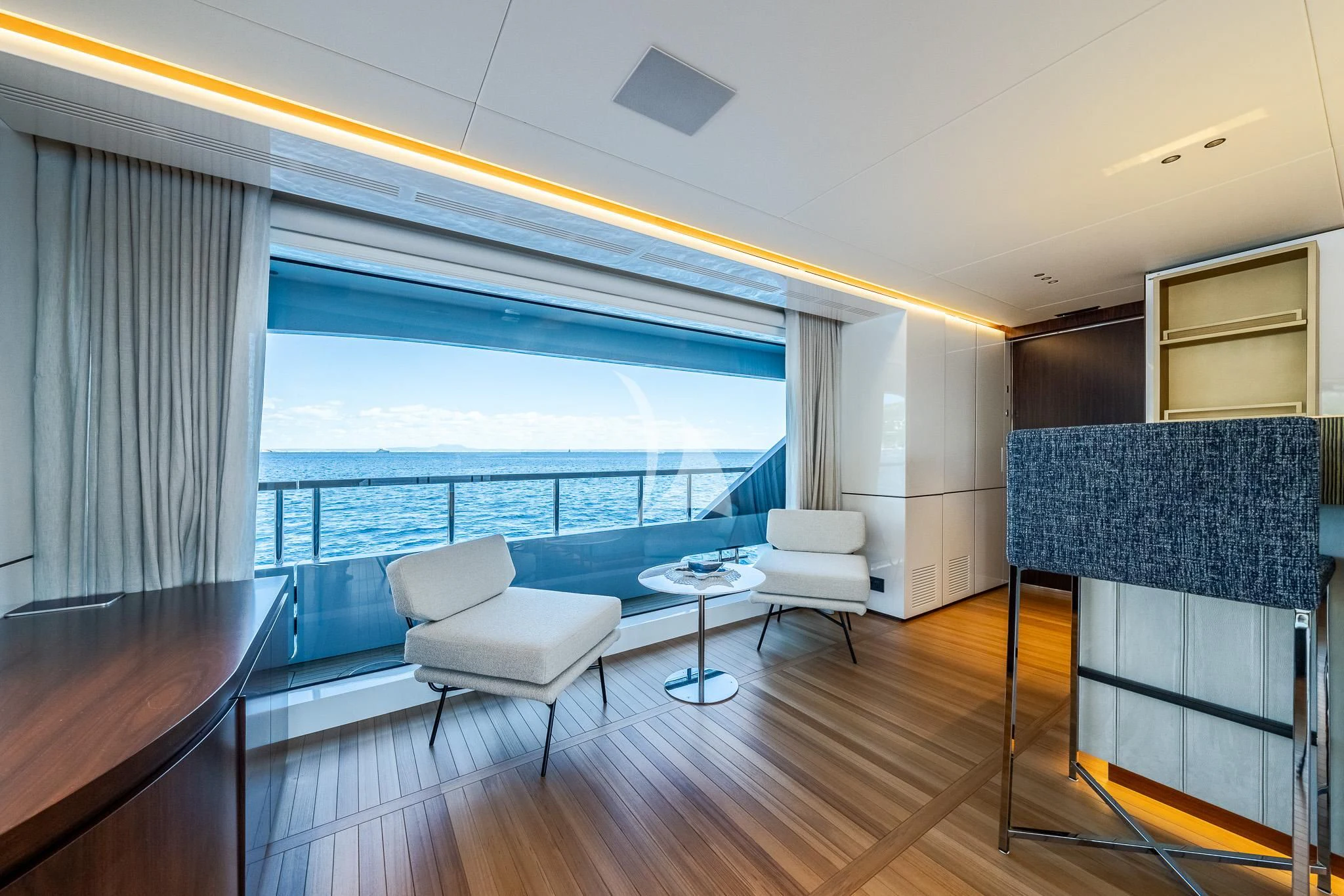 a room with a table chairs and a large window aboard TOSUN Yacht for Sale