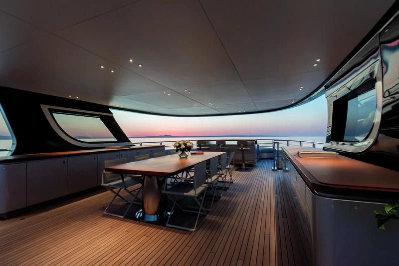 a room with a table and chairs aboard TOSUN Yacht for Sale