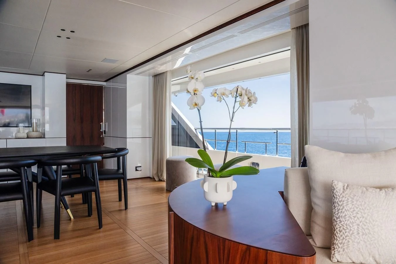 a living room with a table and couches aboard TOSUN Yacht for Sale