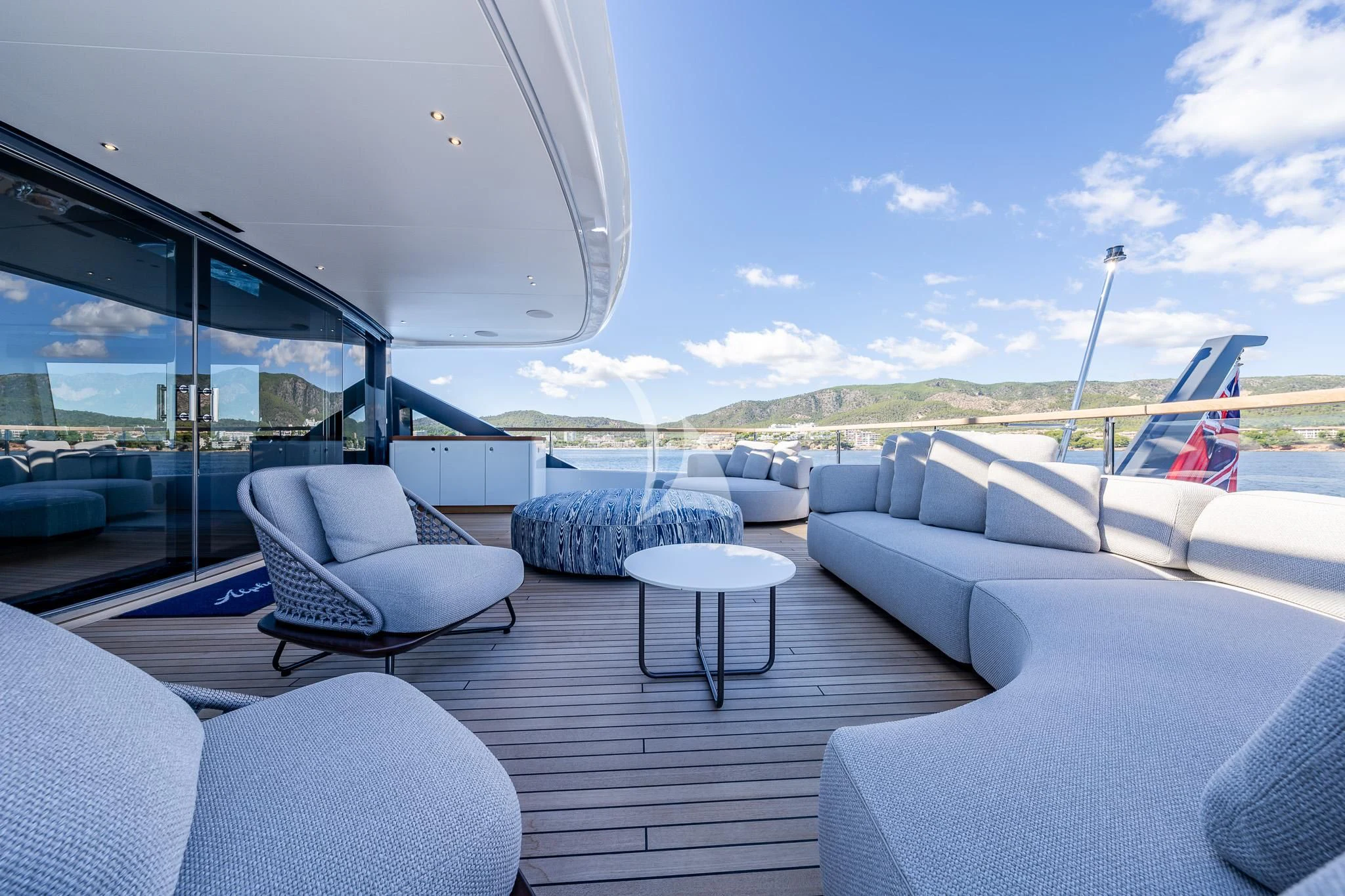 a large living room with a view of the ocean and mountains aboard TOSUN Yacht for Sale