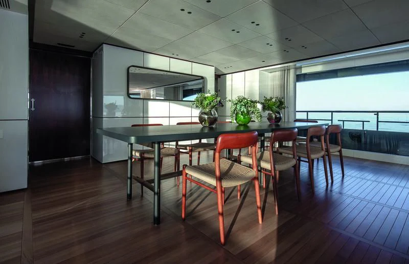 a room with a table and chairs aboard TOSUN Yacht for Sale