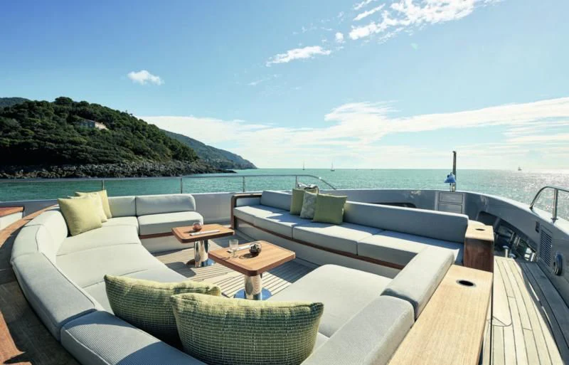 a deck with a view of the ocean and a beach aboard TOSUN Yacht for Sale
