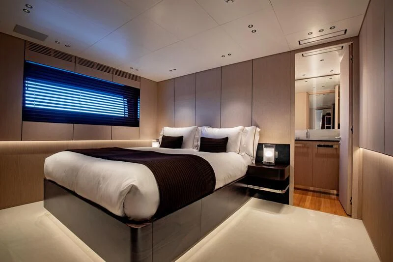 a room with a bed and a tv aboard TOSUN Yacht for Sale