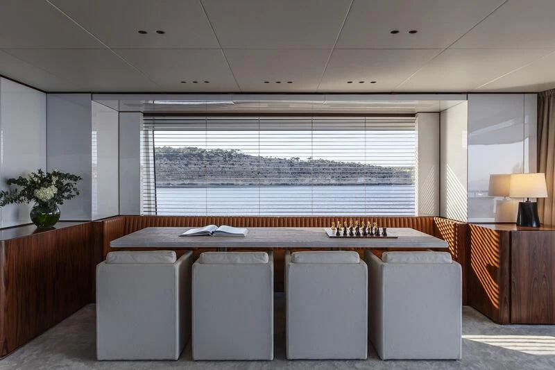 a room with a table and chairs aboard TOSUN Yacht for Sale