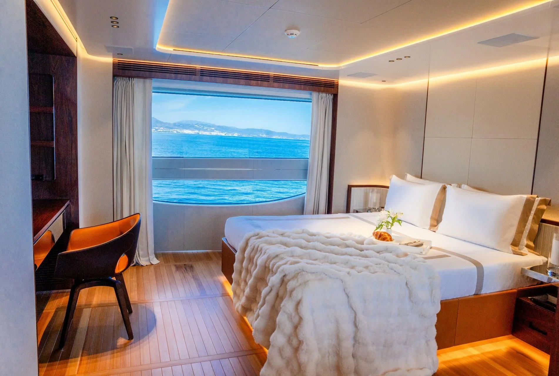a room with a bed and a window aboard TOSUN Yacht for Sale