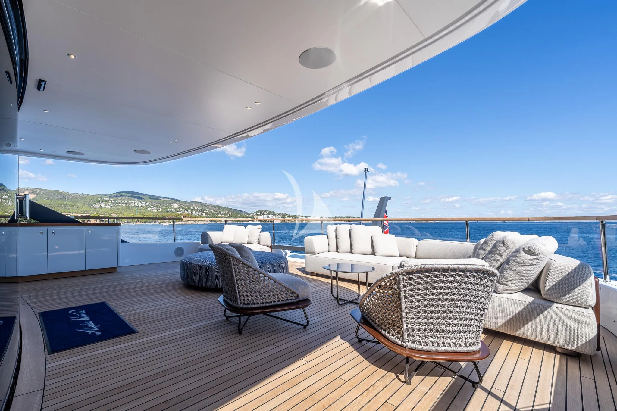 a deck with chairs and a view of the ocean aboard TOSUN Yacht for Sale