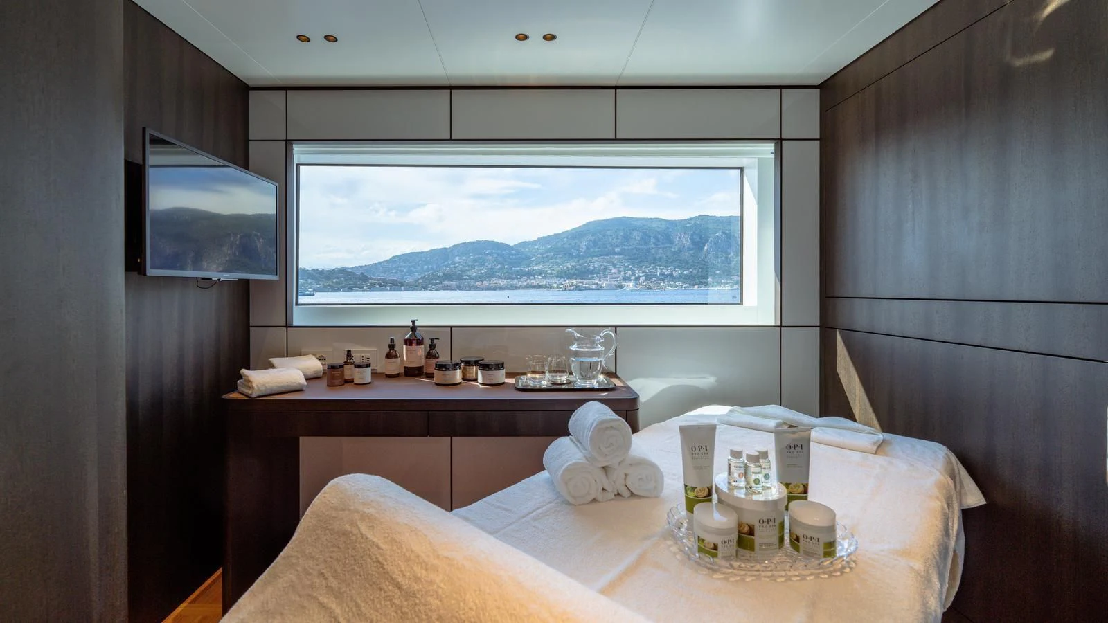 a room with a bed and a television aboard TOSUN Yacht for Sale