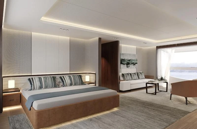 a bedroom with a bed and a table aboard TOSUN Yacht for Sale