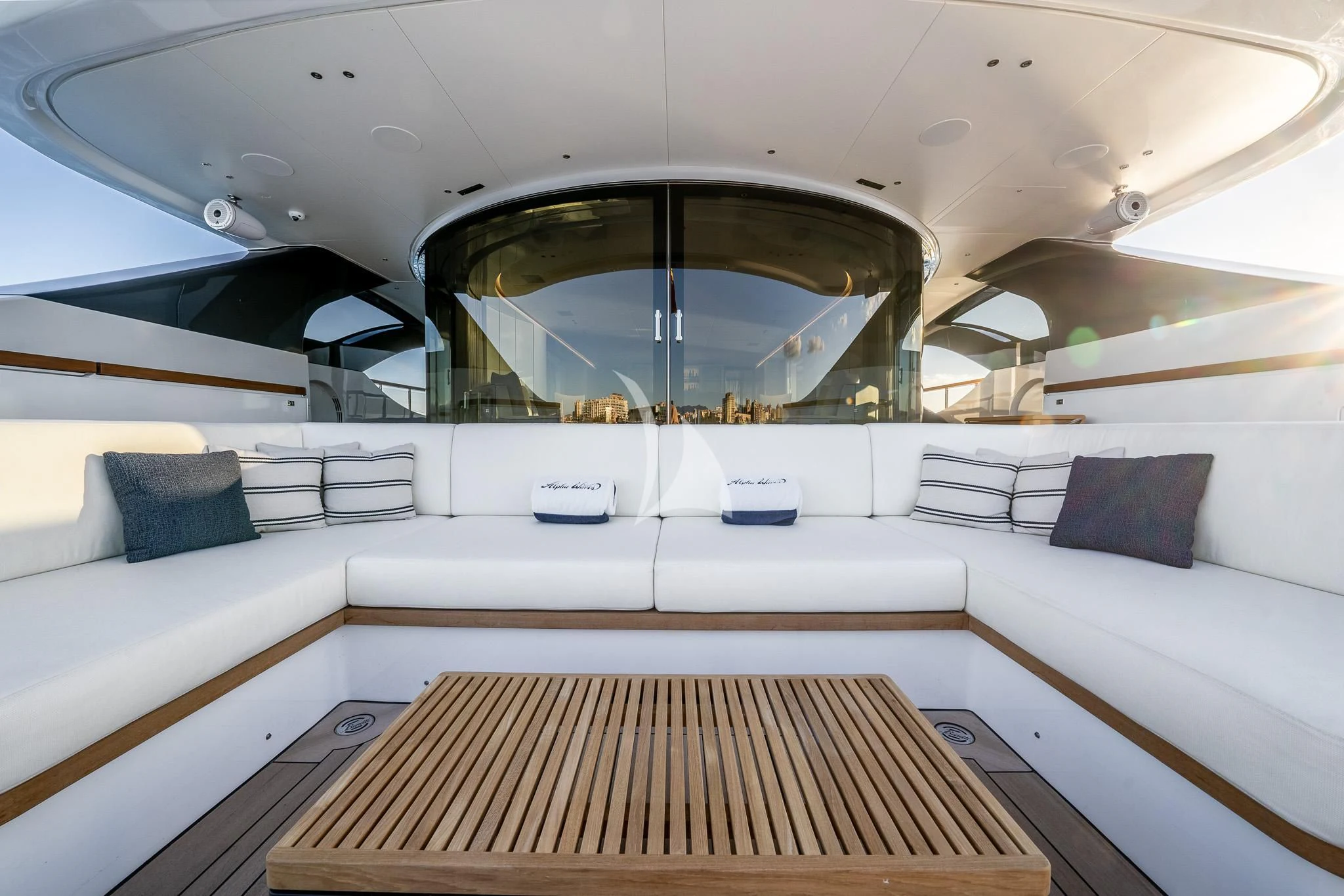 a white couch with a round mirror aboard TOSUN Yacht for Sale