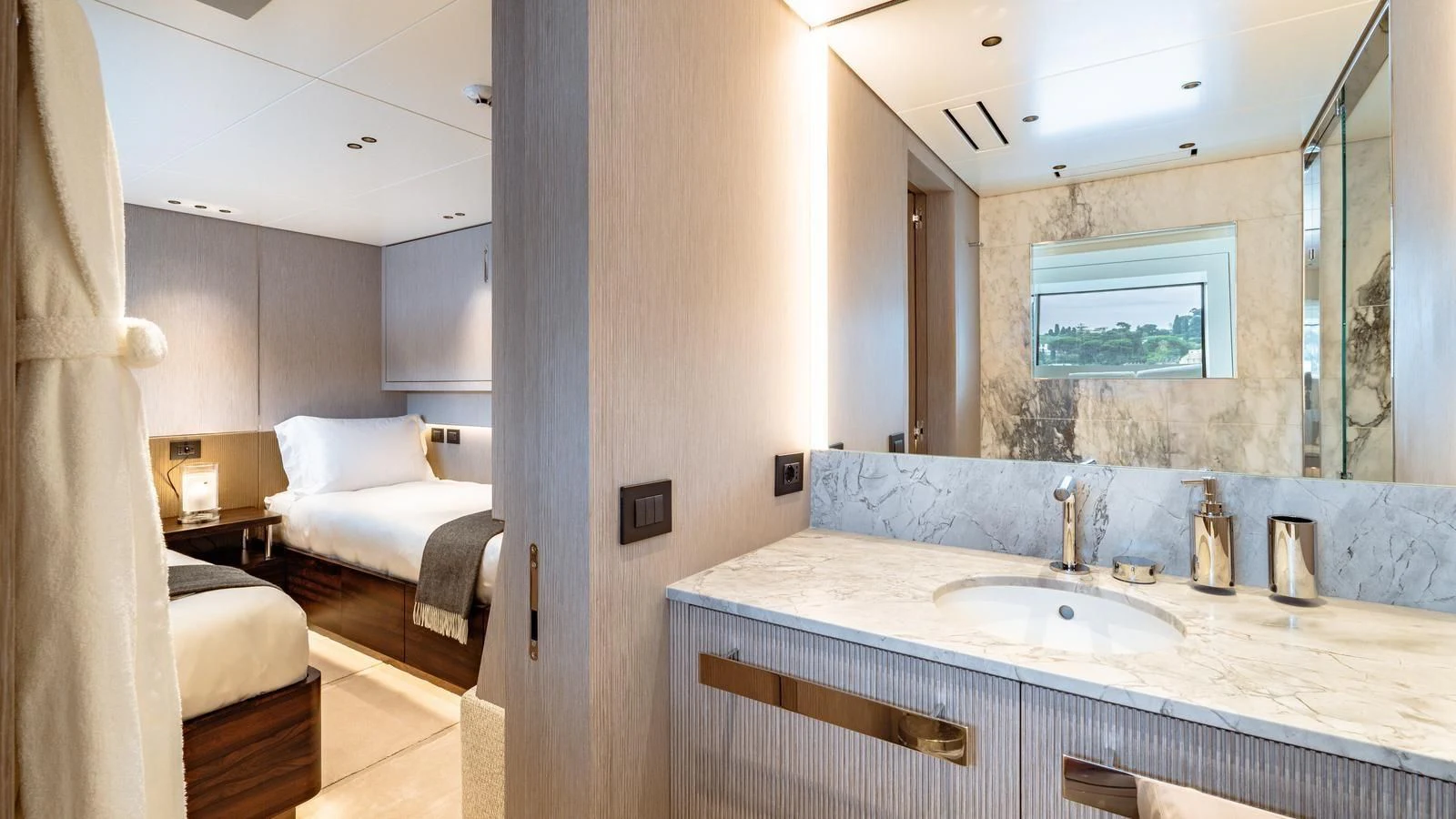 a bathroom with a sink and a bed aboard TOSUN Yacht for Sale