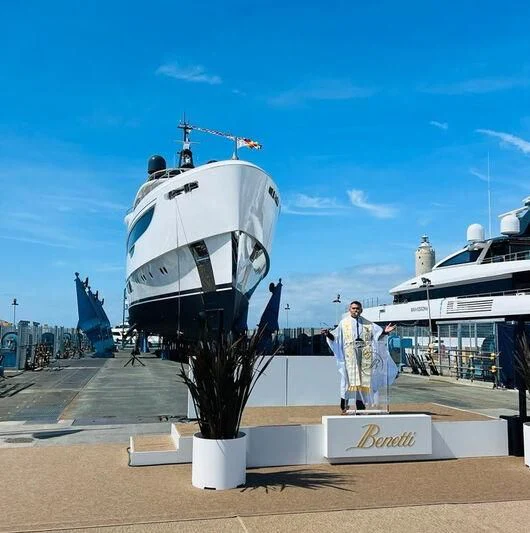 a large white boat with a person standing on it aboard TOSUN Yacht for Sale