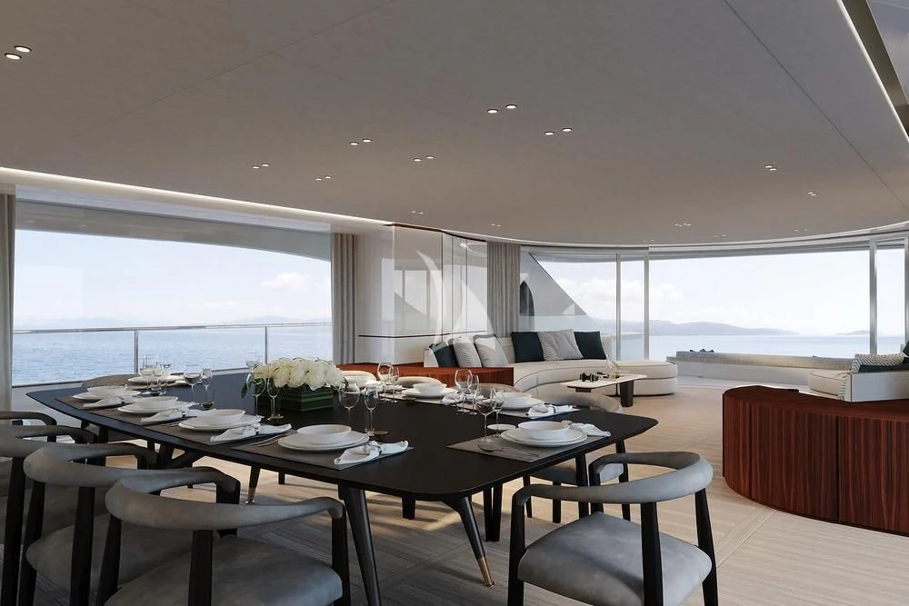 a dining table with a large window overlooking a large body of water aboard TOSUN Yacht for Sale
