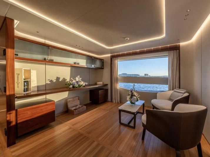 a room with a large window and a wood floor aboard TOSUN Yacht for Sale