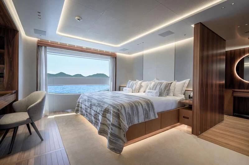 a room with a bed and a window aboard TOSUN Yacht for Sale