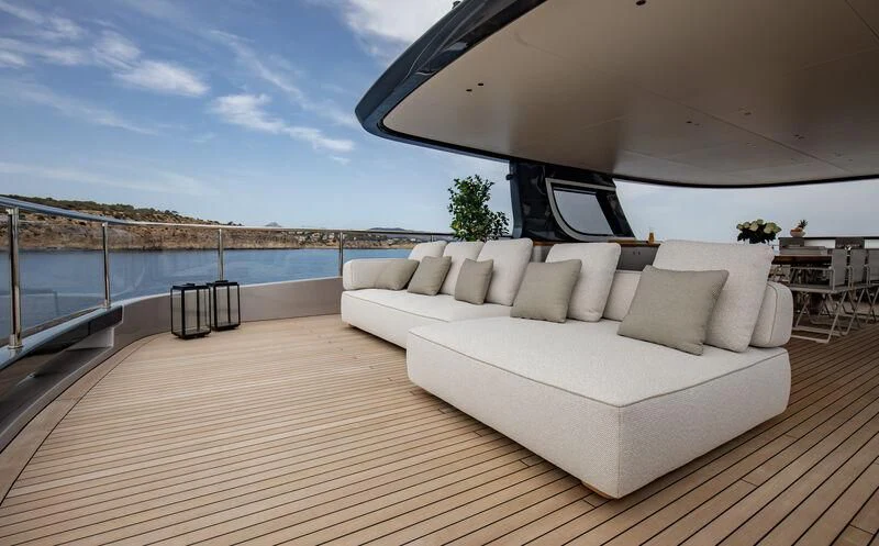 a large white couch on a deck aboard TOSUN Yacht for Sale