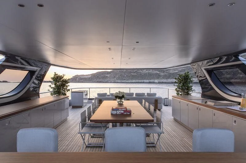 a room with a table and chairs aboard TOSUN Yacht for Sale