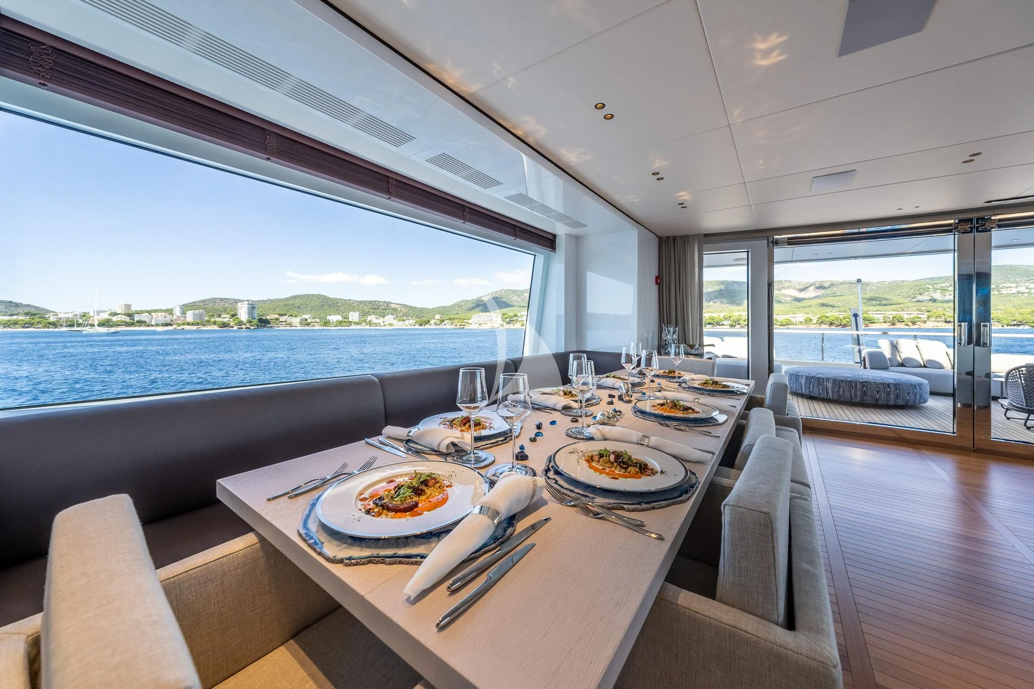 a table with plates and food on it aboard TOSUN Yacht for Sale