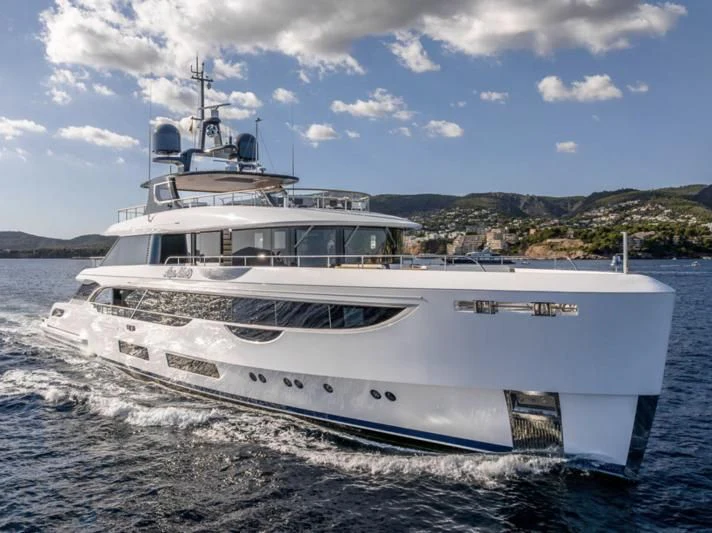 a white boat on a beach aboard TOSUN Yacht for Sale