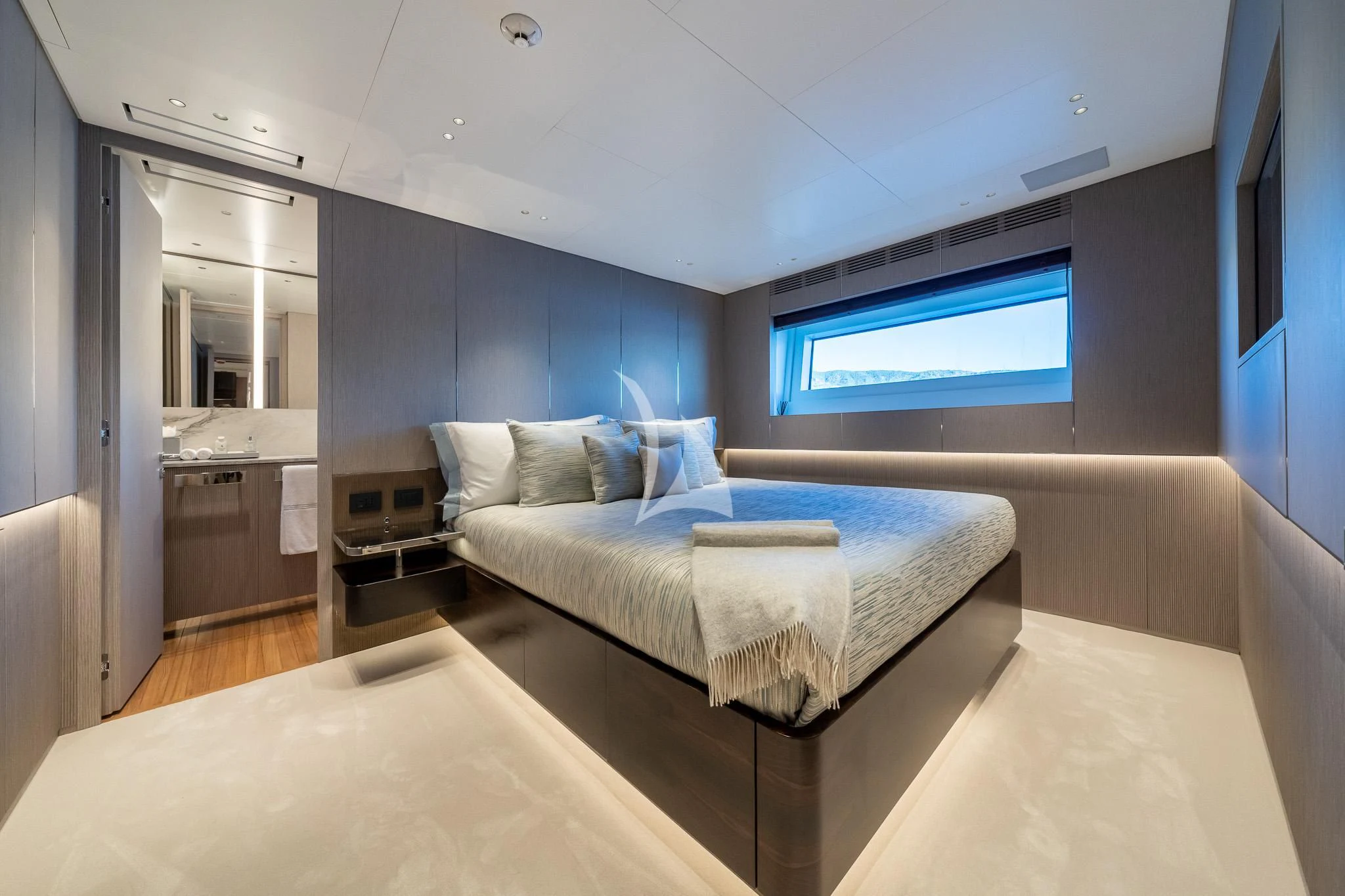 a bedroom with a bed and a window aboard TOSUN Yacht for Sale