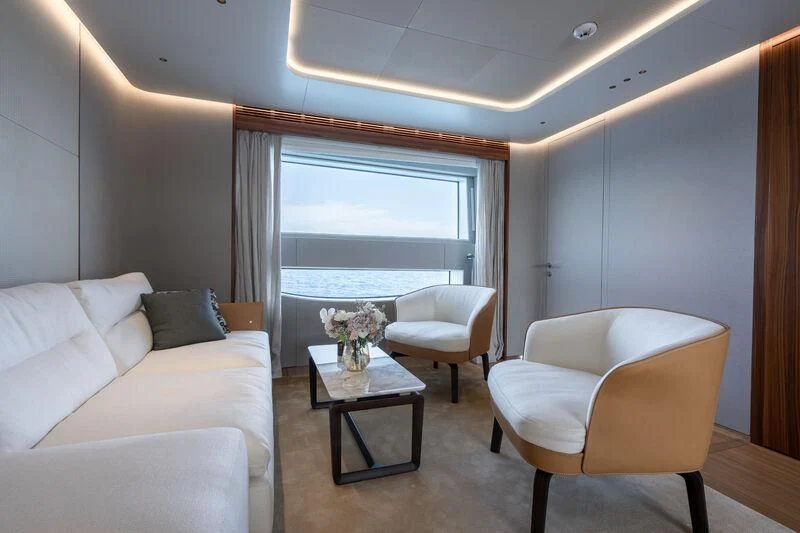 a living room with a table and chairs aboard TOSUN Yacht for Sale