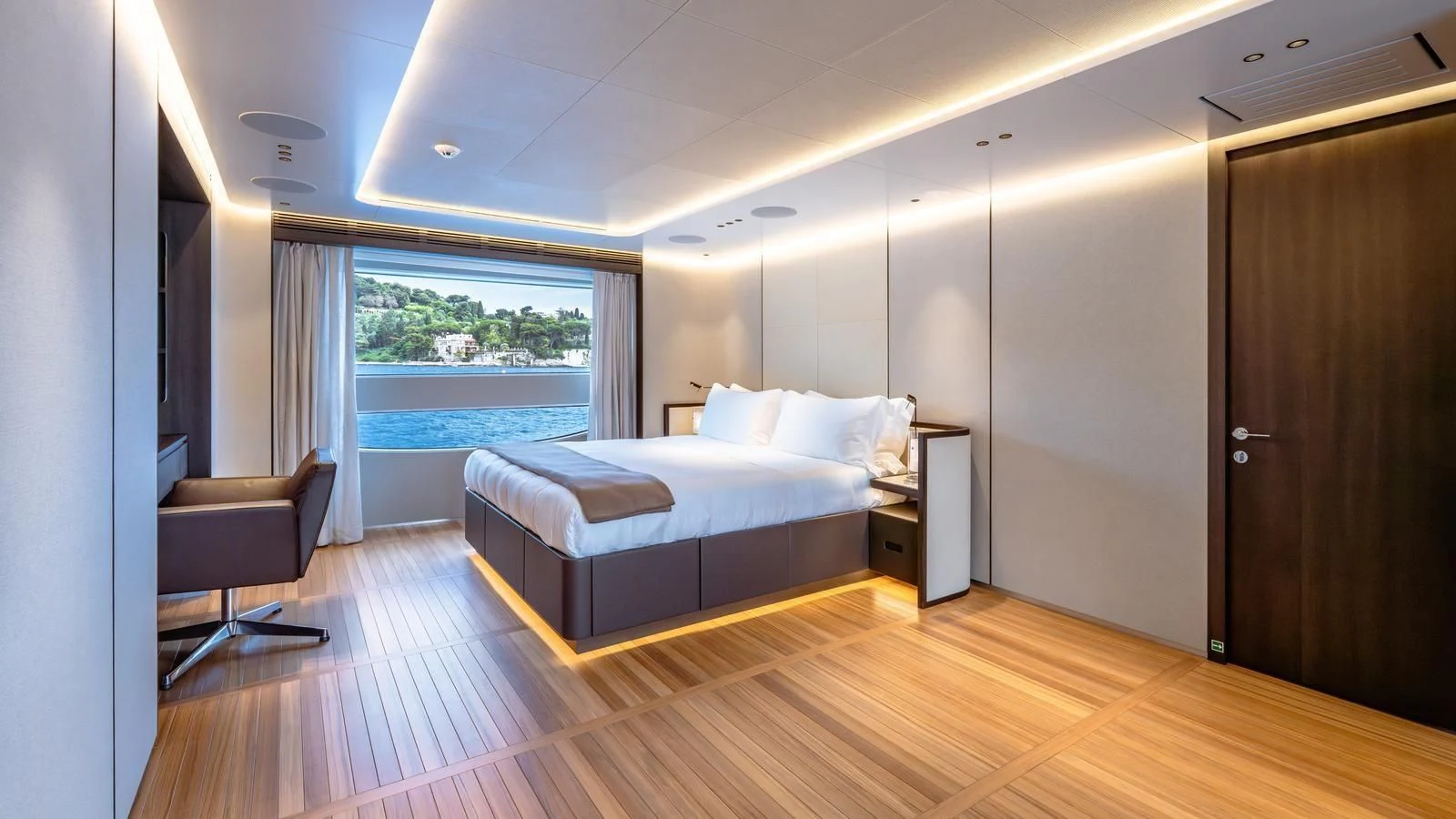 a bedroom with a bed and a chair aboard TOSUN Yacht for Sale