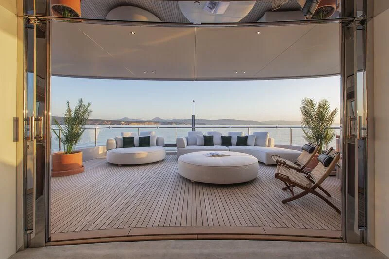 a room with a table and chairs aboard TOSUN Yacht for Sale