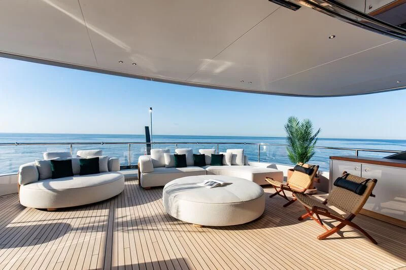 a room with a table chairs and a large body of water aboard TOSUN Yacht for Sale