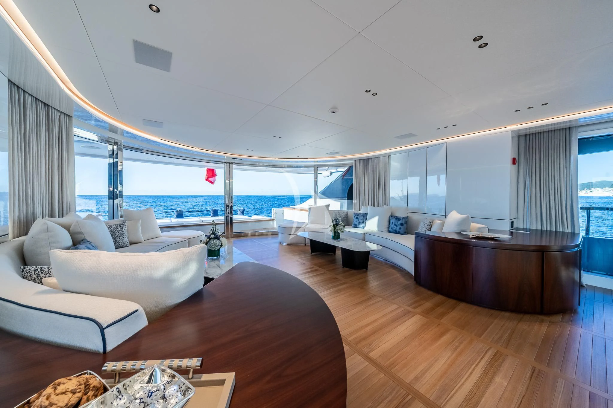 a living room with a large balcony aboard TOSUN Yacht for Sale