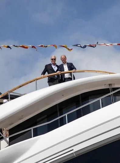 men standing on a balcony aboard TOSUN Yacht for Sale