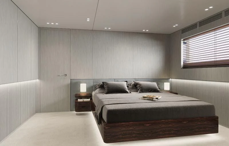 a bedroom with a bed and a table aboard TOSUN Yacht for Sale