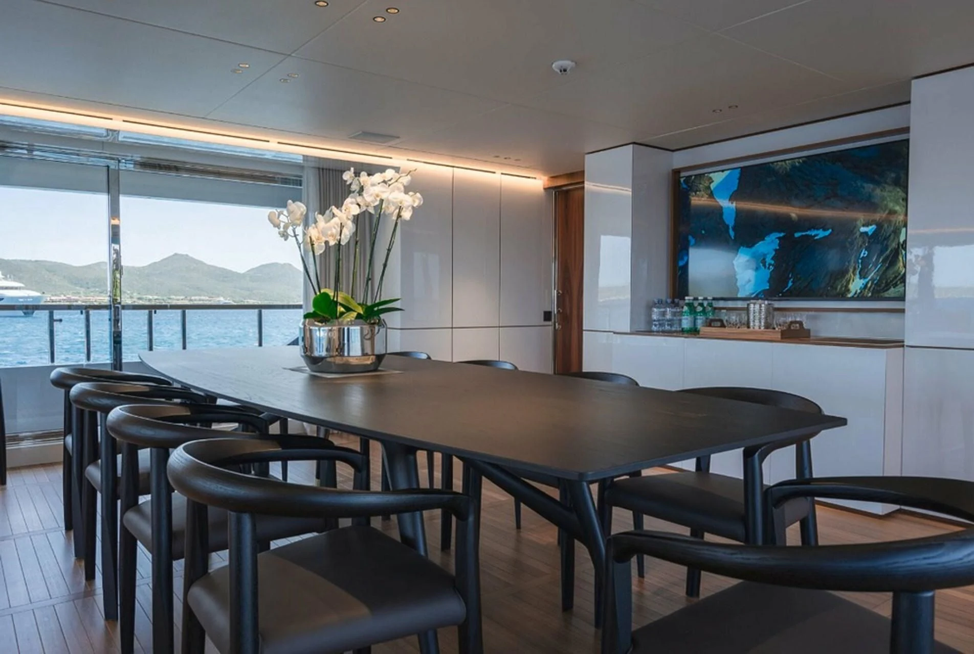 a table with chairs and a tv aboard TOSUN Yacht for Sale
